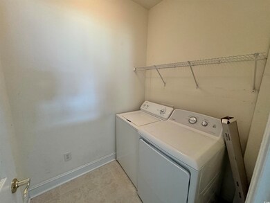 Washroom with light tile patterned flooring and wa