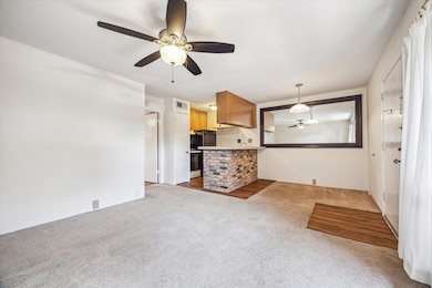 View of living room, dining area, and kitchen.