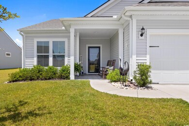 Entrance to property with a lawn, roof with shingles, a porch, and an attached garage