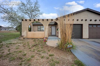 Southwest-style home with stucco siding, driveway,