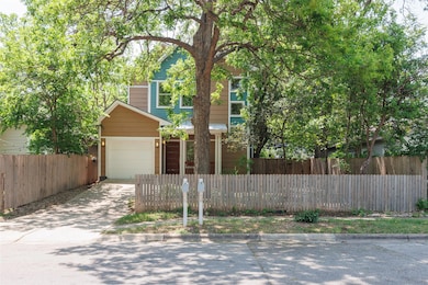 Traditional-style house with a garage, a fenced f
