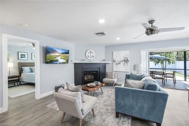 Living room with ceiling fan and light wood-type f