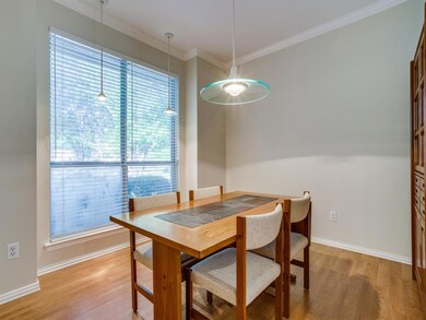 Formal dining has crown molding & pendant lighting