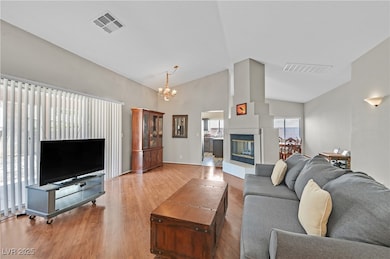 Living area with high vaulted ceiling, a chandelie