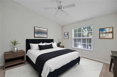 Bedroom featuring lofted ceiling, baseboards, carpet flooring, and ceiling fan