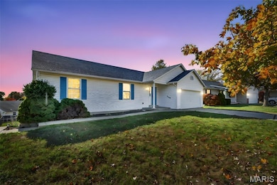 Ranch-style house with a yard, a garage, and driveway