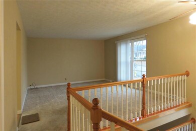 The living room measures 15'4