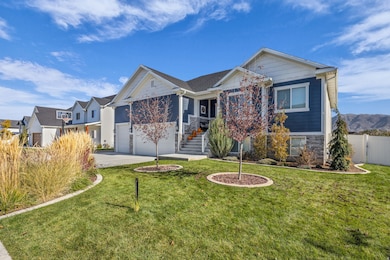 View of front of house with stone siding, driveway, and stairway