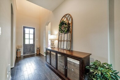 Here is a view of the front door and a bedroom and full bathroom on the right.  Beautiful engineered wood flooring in main living areas.
