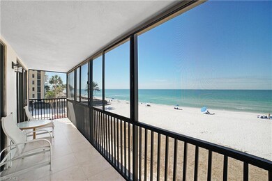 Sunroom / solarium featuring a beach view and a wa