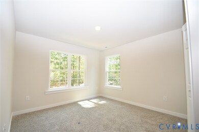 Carpeted empty room featuring baseboards
