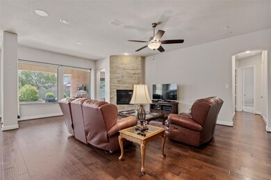 Living room with ceiling fan, dark wood-type floor