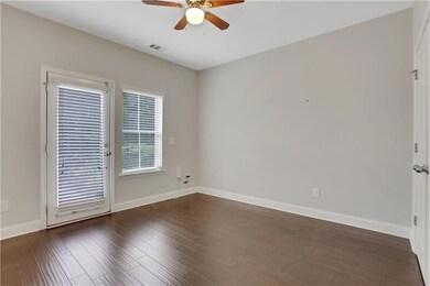 Bedroom with a ceiling fan, baseboards, and wood finished floors