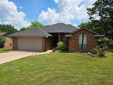 Ranch-style home featuring a garage, roof with shi