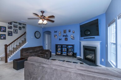 Living room has a ceiling fan.