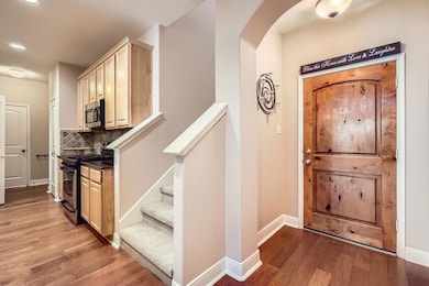 Foyer entrance with arched walkways, recessed lig