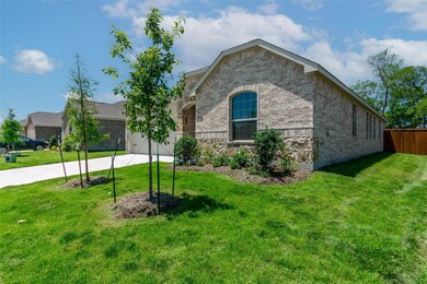 View of front of property with a garage and a front yard