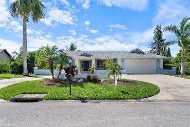 Single story home featuring a front lawn and a gar