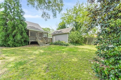 View of yard with an outdoor structure and a sunroom