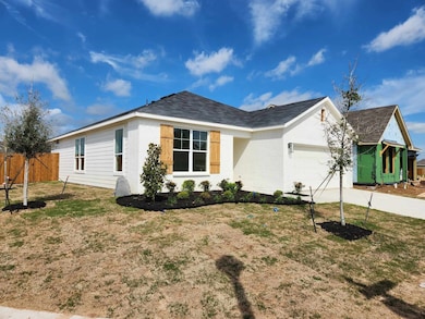 Single story home with a front yard and a garage