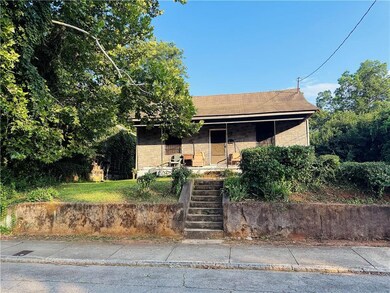View of front of property featuring covered porch and stairway