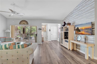 Living room with ceiling fan, french doors, vaulte