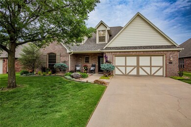 Adorable front elevation with mature tree and landscaping.