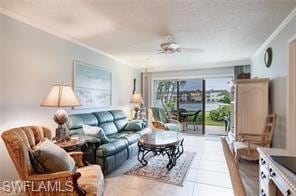 Living room featuring crown molding and ceiling fa