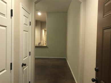 Hall with recessed lighting, concrete flooring, a
