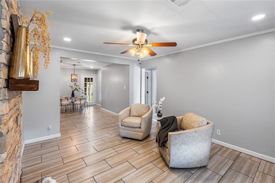 Living area featuring wood finish floors, ornamental molding, recessed lighting, and a ceiling fan