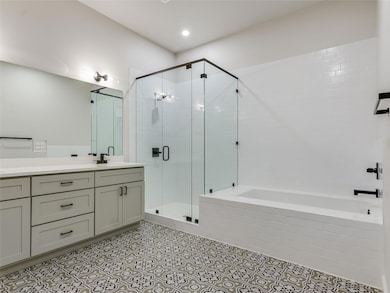 Full bathroom with a garden tub, vanity, a shower