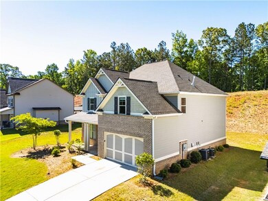 Craftsman inspired home with a shingled roof, a fr