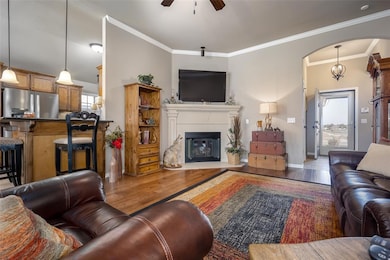 Living room with ceiling fan, hardwood / wood-styl