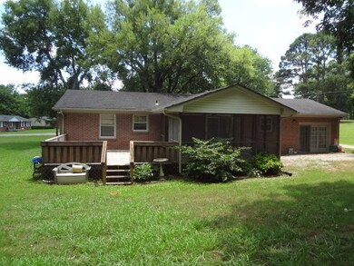Back yard shows screened in porch and deck.