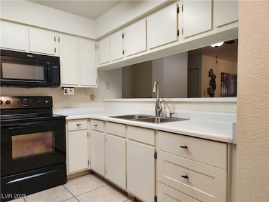 Larger galley kitchen with view through to the din