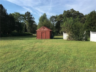 View of yard featuring a shed and an outdoor struc