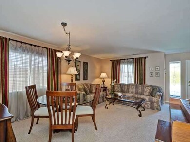 Living/dining room combo.  Entry way window has le