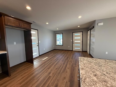 Looking from Kitchen to Dining area and front entr
