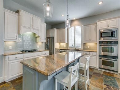 The updated kitchen includes white cabinets, gray 