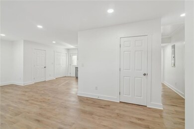 Empty room featuring recessed lighting, light wood-style flooring, and baseboards