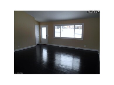 A large living room with espresso colored hardwood