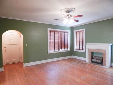 Large living room with decorative fireplace and wo