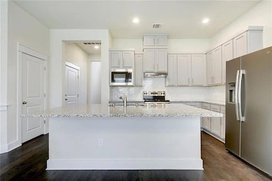 Kitchen featuring stainless steel appliances, a s