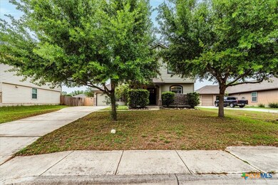 Great curb appeal with lovely, manicured trees.