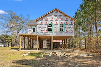 Unfinished property featuring a carport and a fron