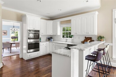 Kitchen featuring backsplash, light stone countert