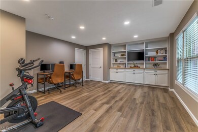 Flexible space with custom built ins, luxury flooring and closet located off front entrance on street level.