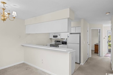 Kitchen with white appliances, kitchen peninsula, 