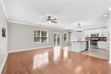 Unfurnished living room with crown molding, light 