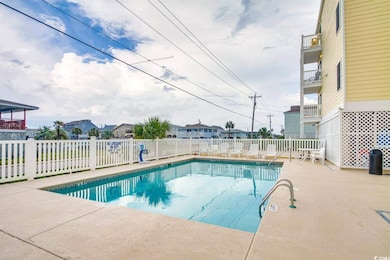 Pool with a patio and fence